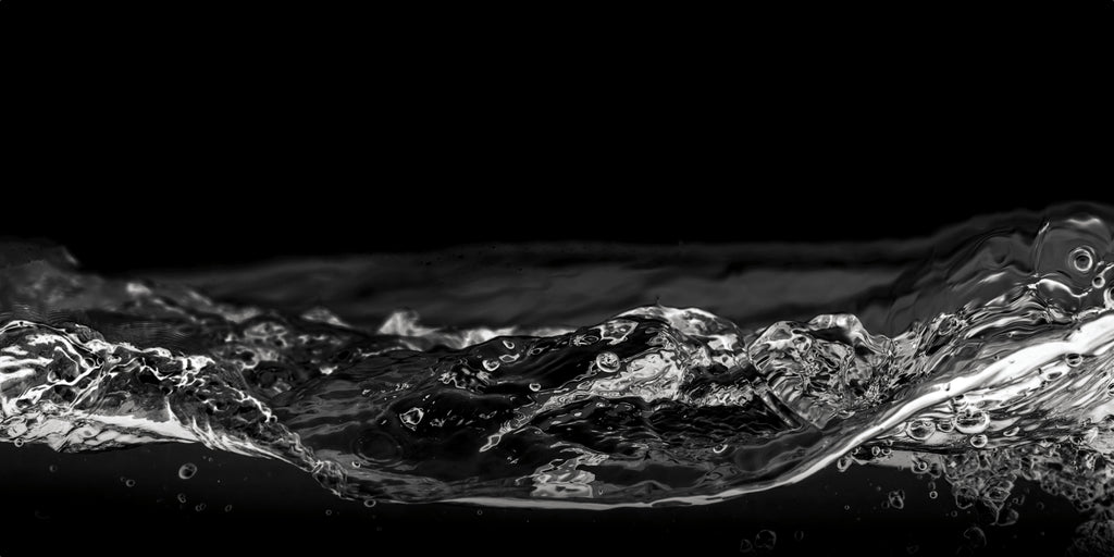Close-up of water surface with ripples on a black background