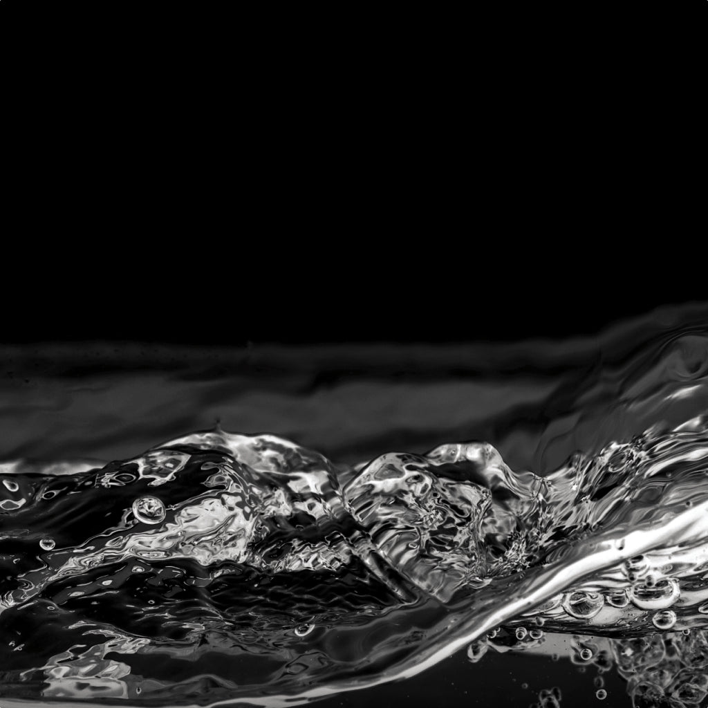 Close-up of water with water droplets on a black background
